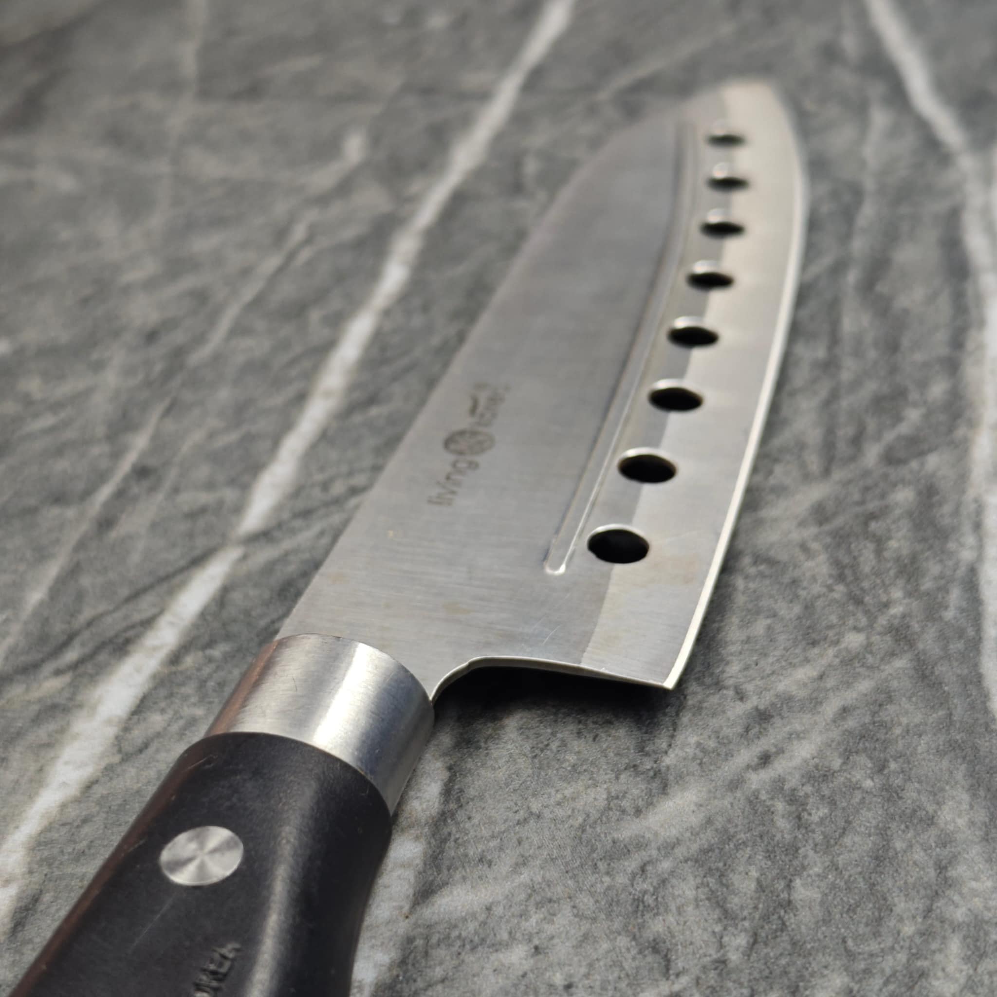 Chef knife with holes showing sharp edge detail