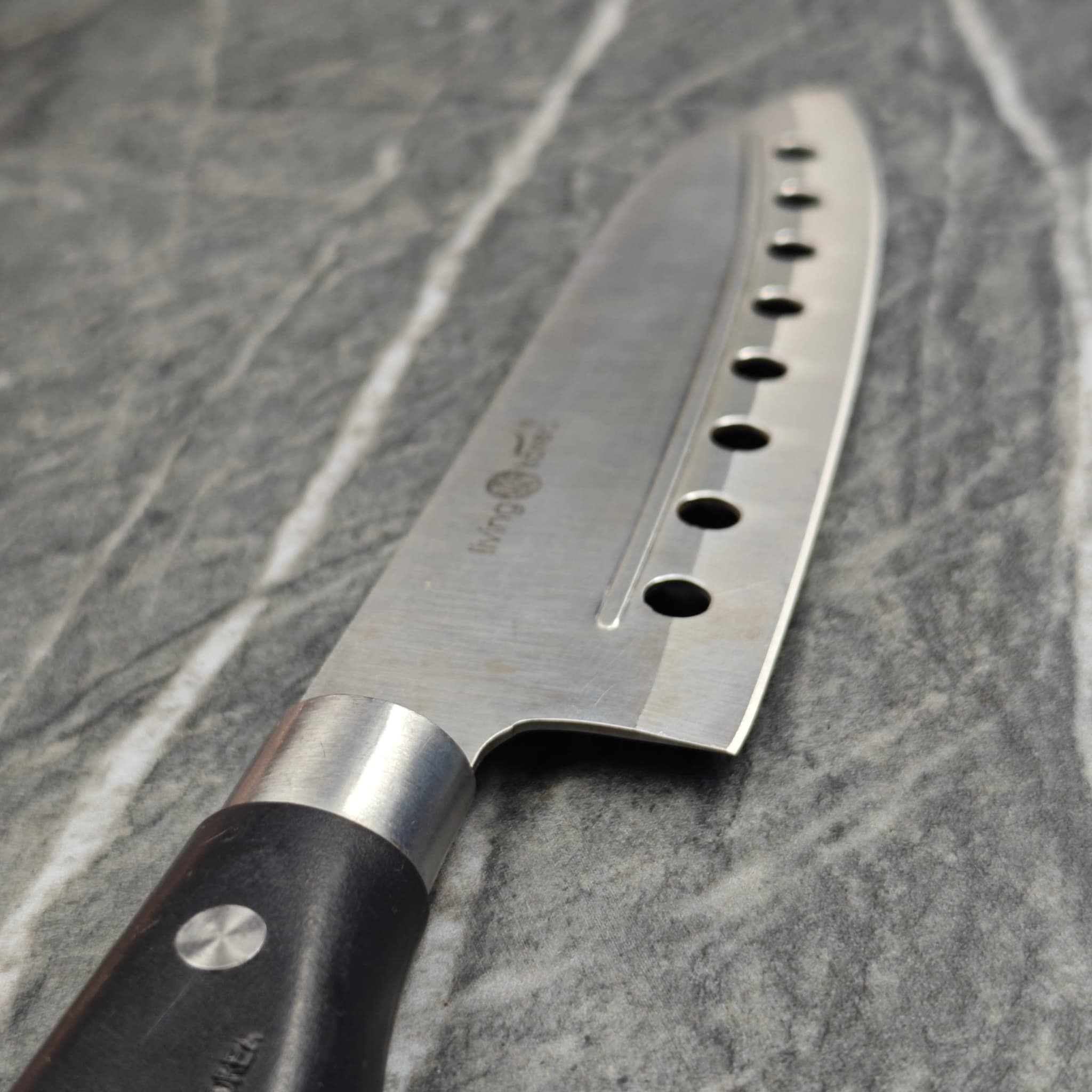 Chef knife with holes sharpened and polished
