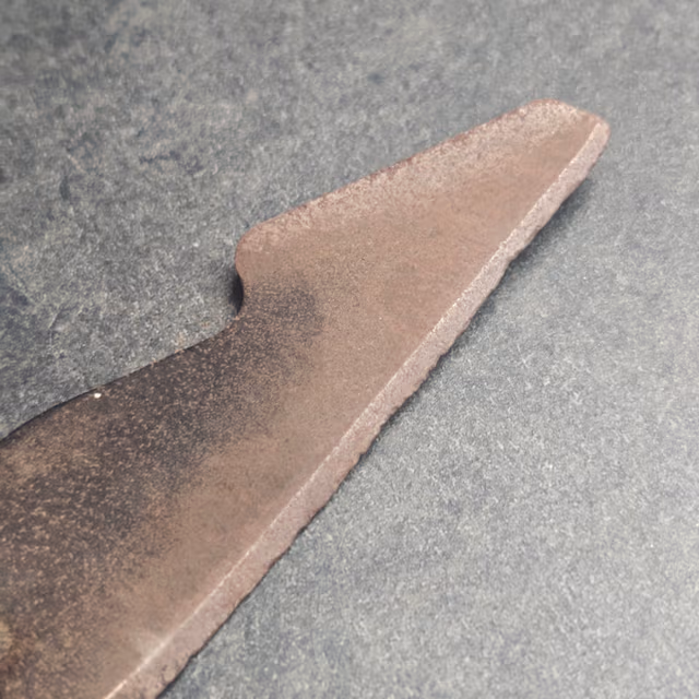 Sharp mower blade close-up showing polished bevel and clean cutting edge after professional sharpening in Austin TX