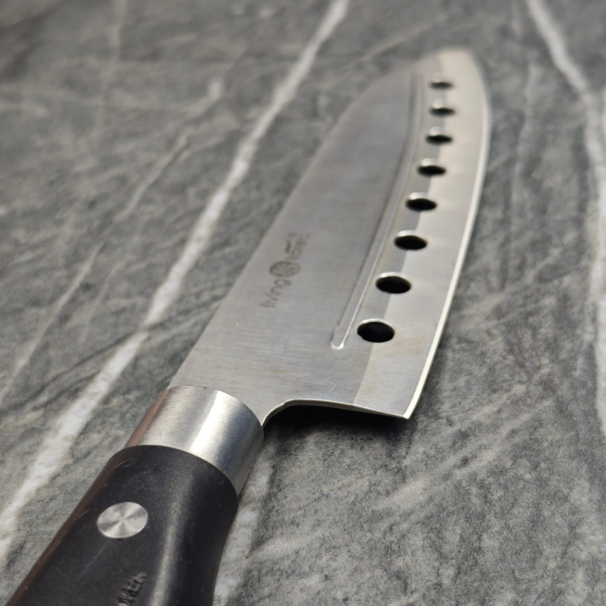 Chef knife with holes showing sharp edge detail