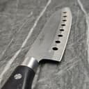 Chef knife with holes showing sharp edge detail