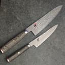 Two Damascus chef knives with wooden handles