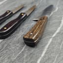 Beautiful wooden-handled folding knife with exotic wood pattern and brass rivets