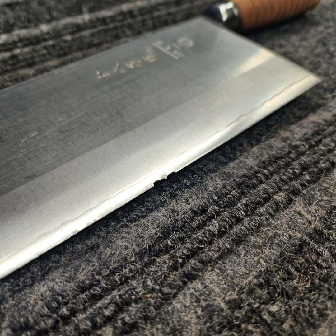 Japanese cleaver edge chipped after cutting into bone