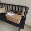 Amazon box returned on a porch bench after sharpening