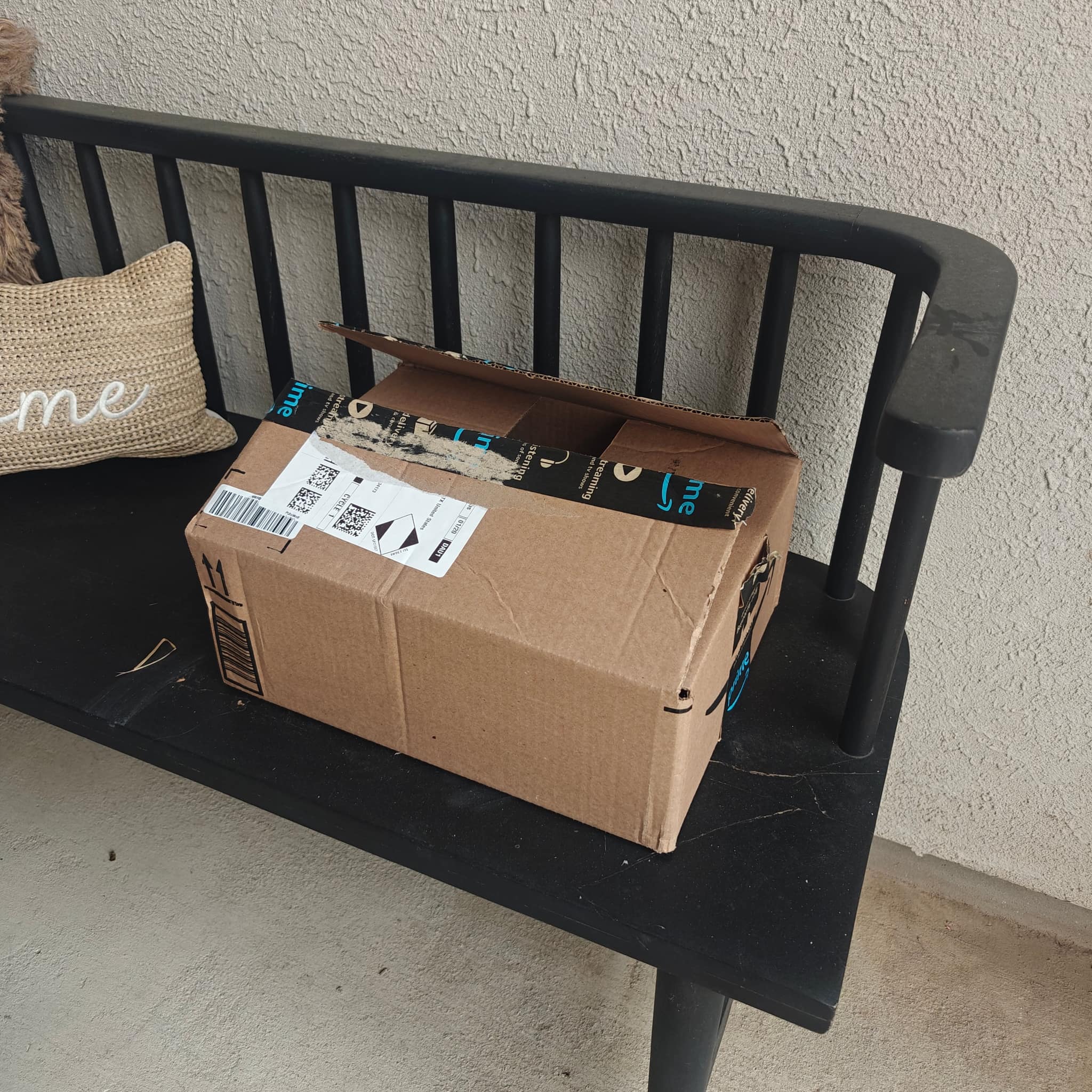 Amazon box returned on a porch bench after sharpening