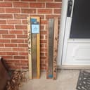 Long blades labeled for porch pickup against a brick wall